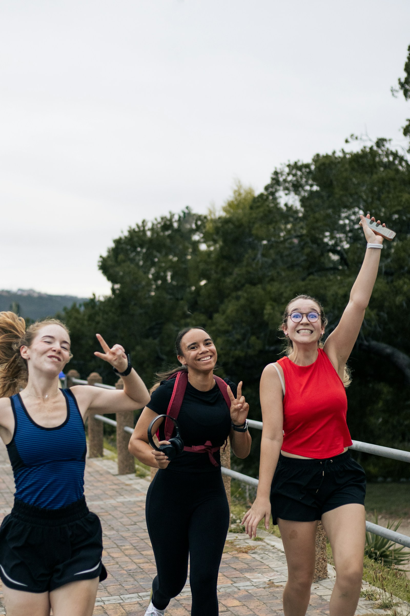 Three friends smiling together on an outdoor run